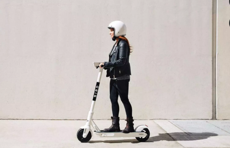 a woman on a bird scooter